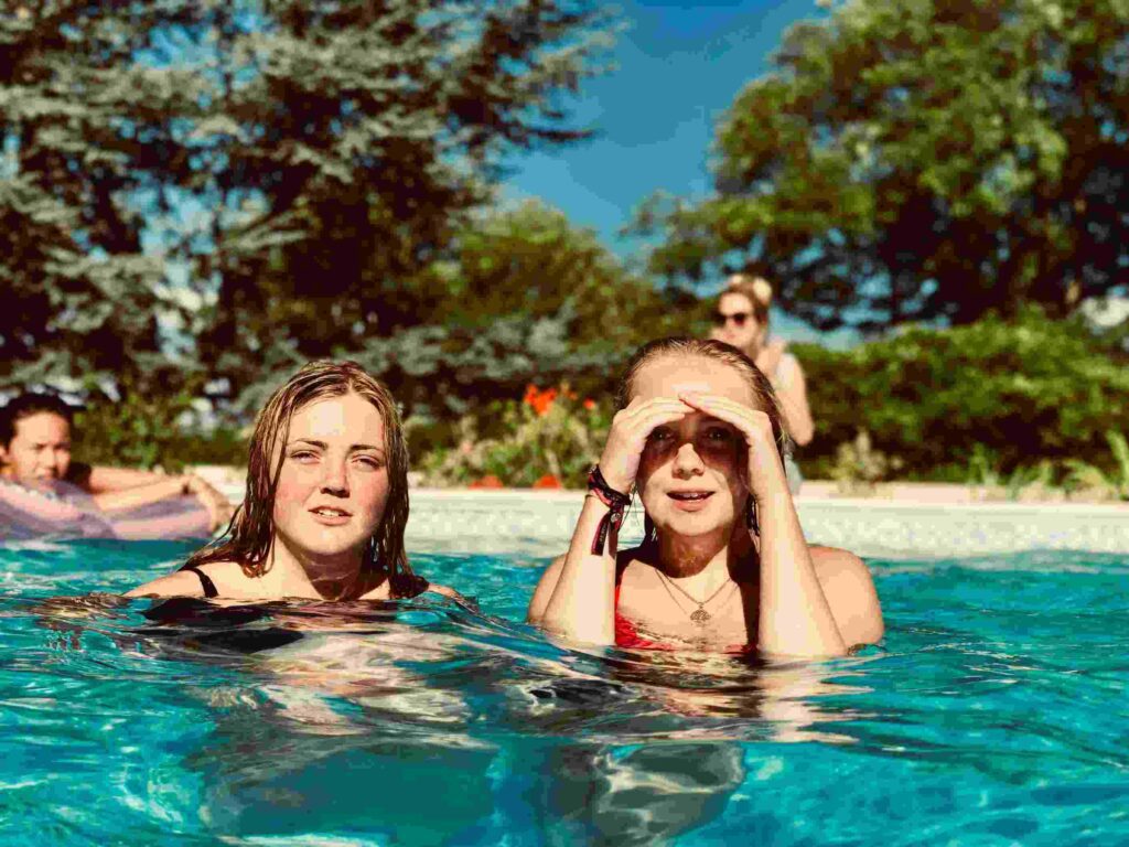 Adult swimming student learning basic techniques with instructor.