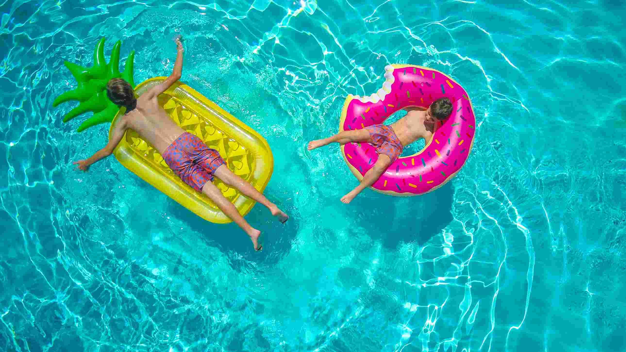 An adult beginner learning swimming basics with an instructor.